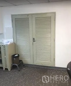 Office Space for rent in Khlong Toei, Bangkok - Double louvered closet doors inside the office next to filing storage.