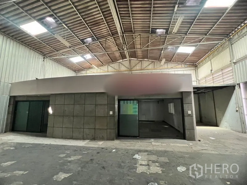 Warehouse for rent in Suan Luang, Bangkok - Front of the internal office block inside the warehouse with sliding glass doors.
