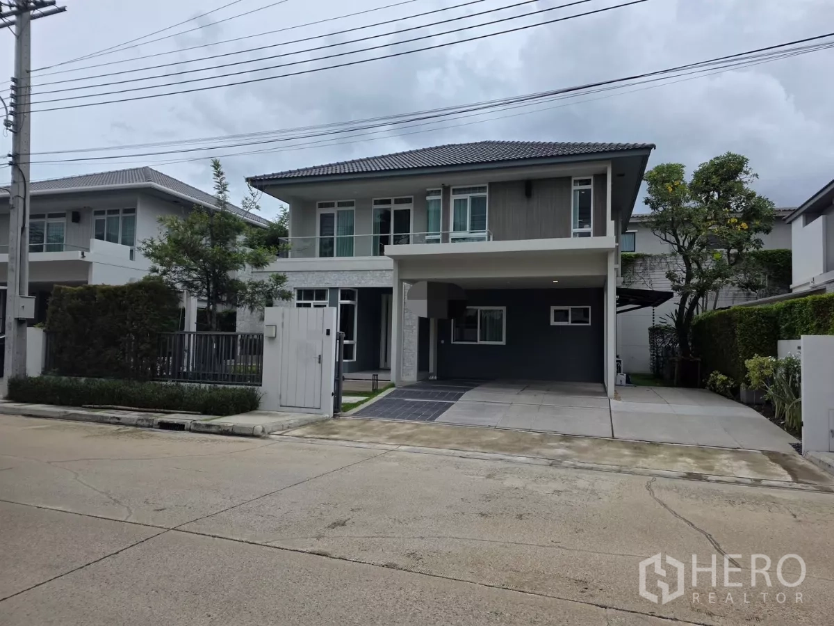 Detached House for rent in Prawet, Bangkok - Two-storey modern detached house with covered carport and wide driveway on a quiet gated street.
