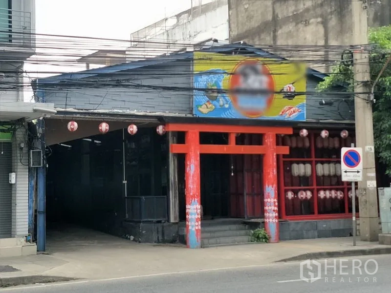Retail Space for rent in Khlong Toei, Bangkok - Streetfront retail façade with red torii-style entrance and large display windows.
