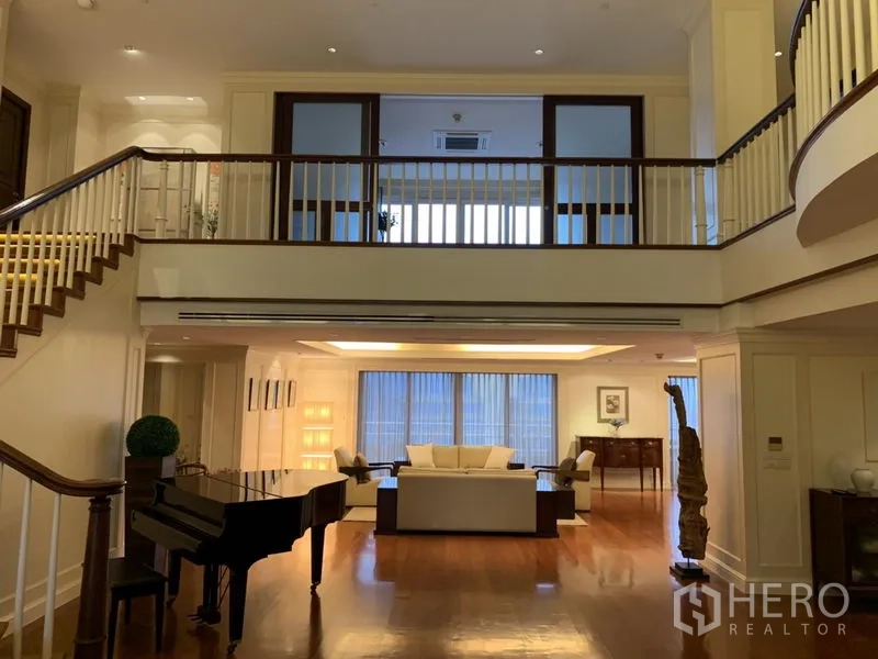 公寓 出租或出售在Watthana, Bangkok - 夹层走廊俯瞰宽敞客厅，可见多组沙发与三角钢琴。