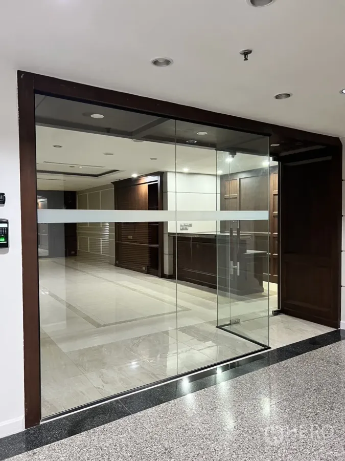Office Space for rent in Watthana, Bangkok - Glass-fronted office entrance with wood trim and tiled lobby.