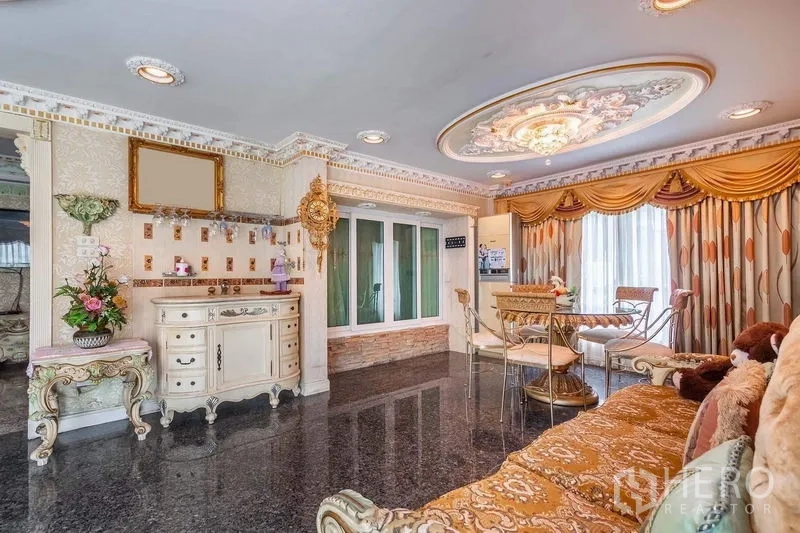 Detached House for rent or sale in Bang Khen, Bangkok - Bright dining lounge with decorative ceiling medallion, granite floor, gold drapes, and a pantry corner.