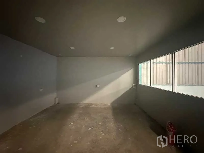 Warehouse for rent in Phra Nakhon Si Ayutthaya - Compact internal office room with windows and recessed ceiling lights inside the warehouse.