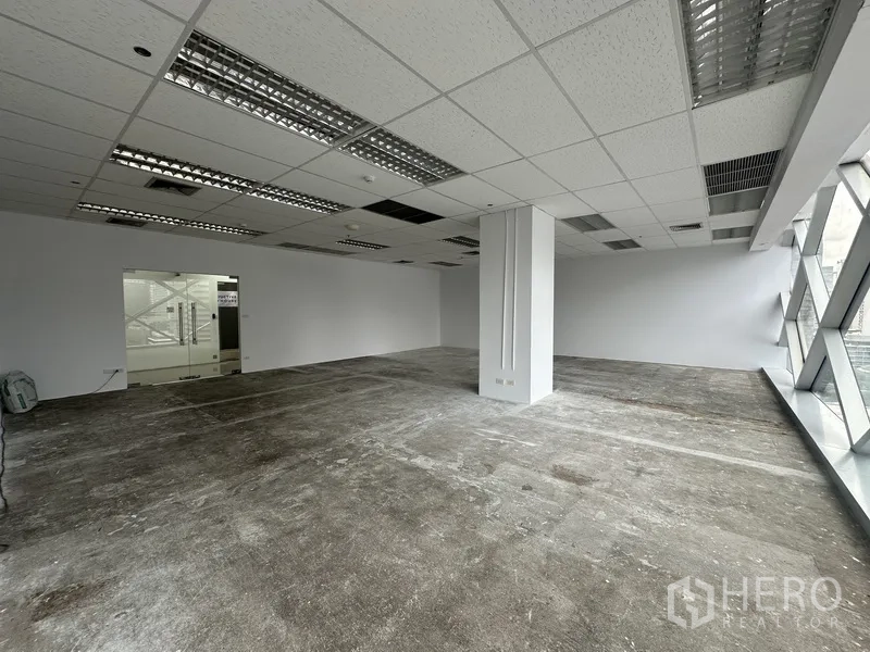 Office Space for rent in Watthana, Bangkok - Office interior with a glass entry door and diagonal braced windows.