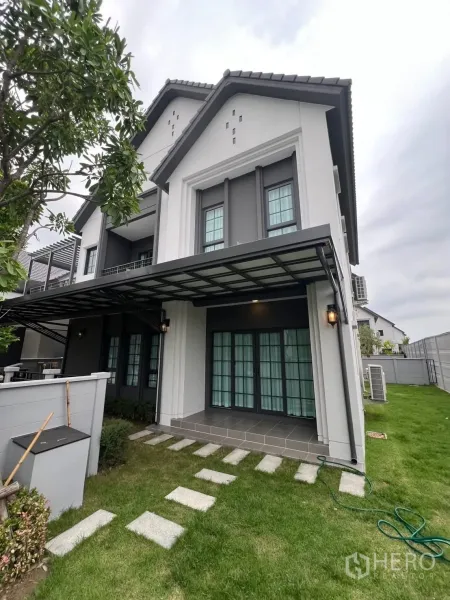 บ้าน ให้เช่าในBang Phli, Samut Prakan - มุมข้างบ้านมีเฉลียงมุงหลังคา ประตูบานเฟรนช์ และทางเดินแผ่นทางเท้า