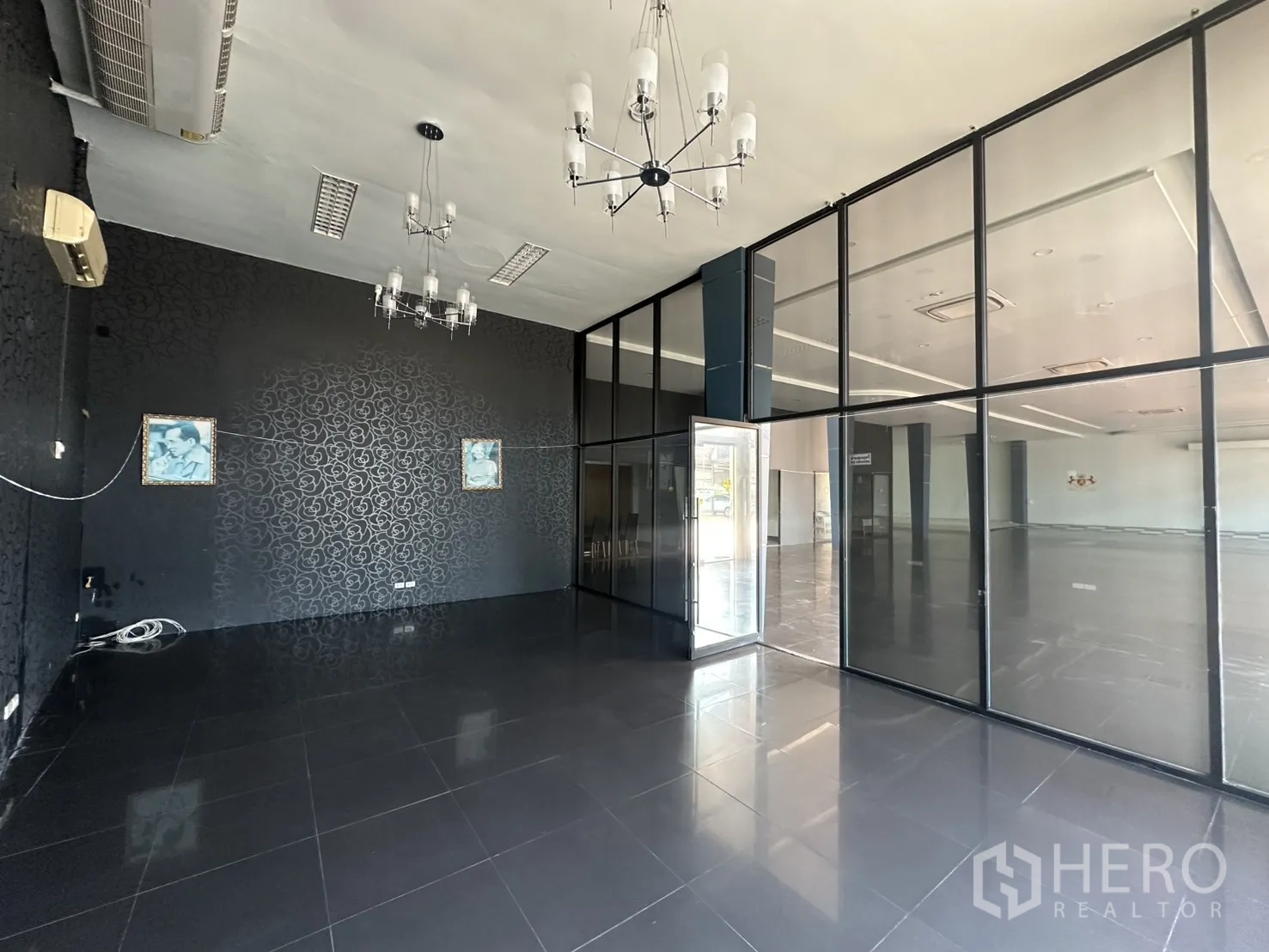 Showroom for rent in Suan Luang, Bangkok - Private office featuring dark accent wall, chandelier lighting, and tiled floor.