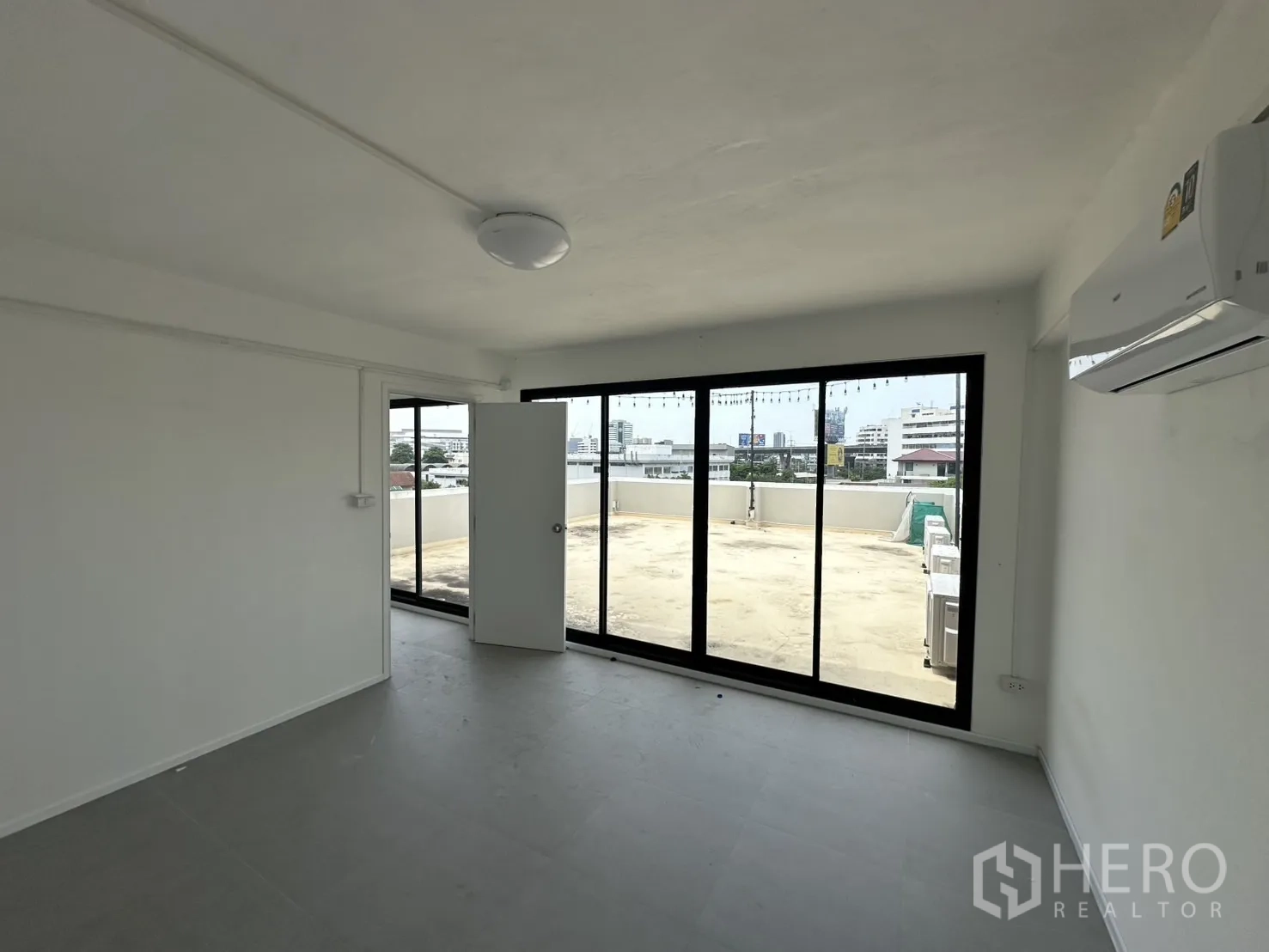 Home Office for rent or sale in Bang Na, Bangkok - Room with door to expansive rooftop terrace and city views.
