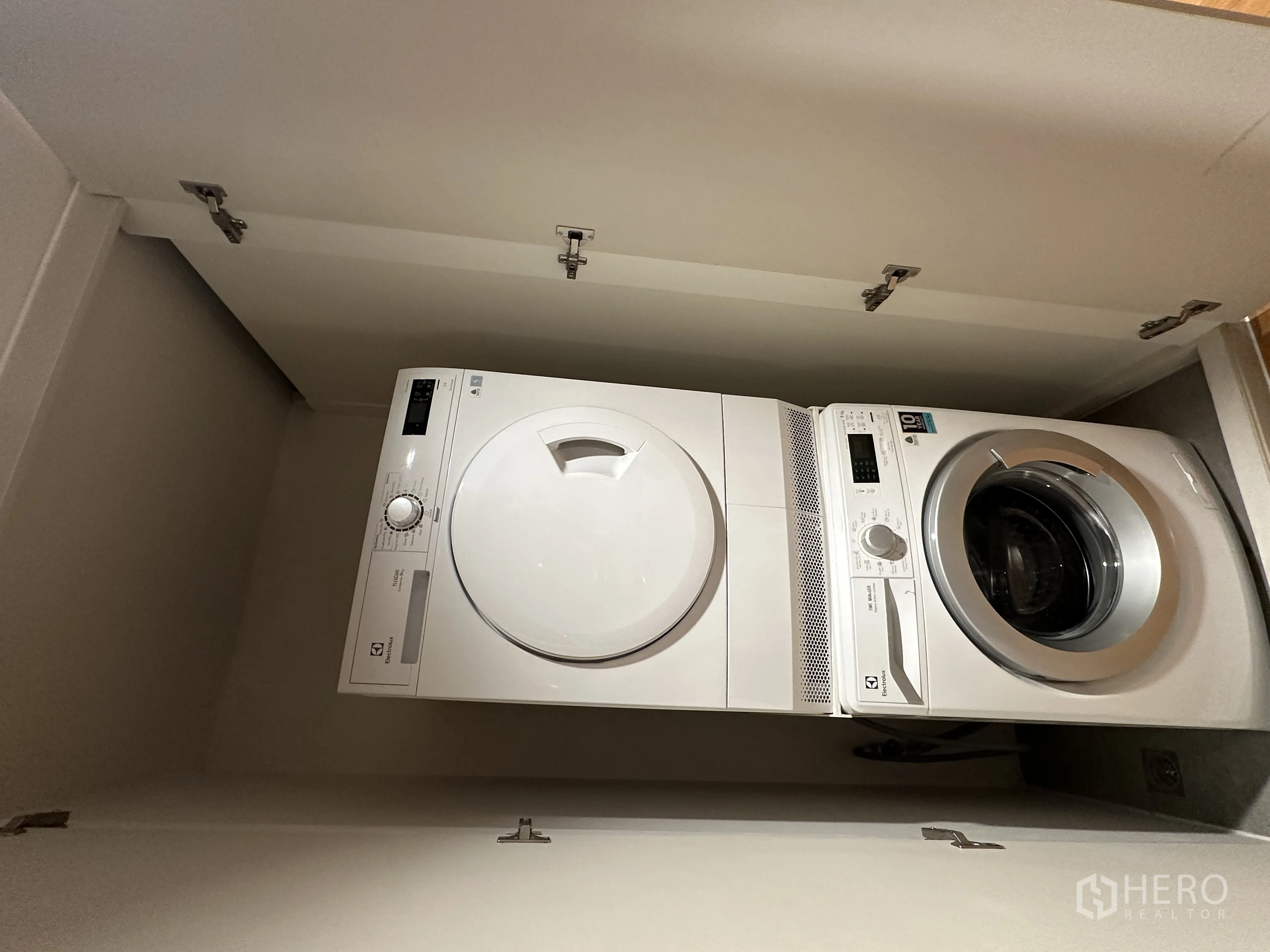 Condominium for rent in Khlong Toei, Bangkok - In-unit laundry closet with front-load washer and dryer.