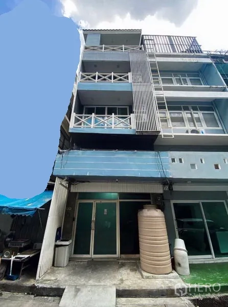 Townhouse for rent in Ratchathewi, Bangkok - Multi-storey townhouse exterior with balconies, sliding glass doors and a small front court.