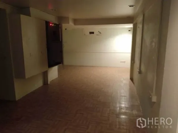 Retail Space for rent in Watthana, Bangkok - Rear area with tiled flooring and an electrical cabinet, ideal for storage or back office.