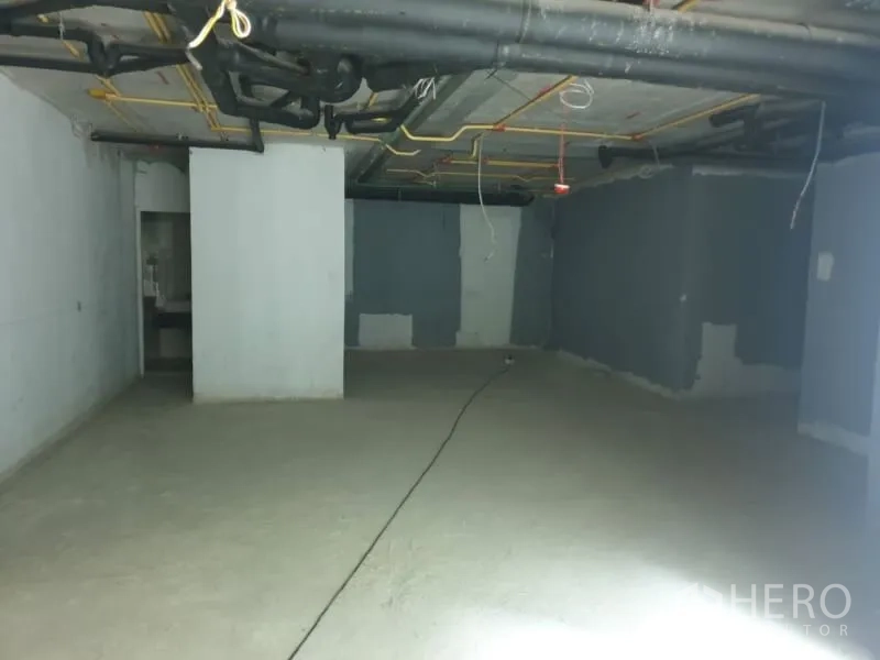 Retail Space for rent in Watthana, Bangkok - Open-plan retail space showing columns and exposed pipes ready for fit-out.