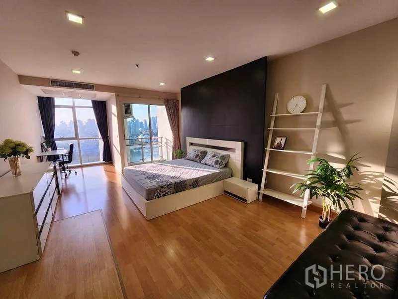 Condominium for rent in Khlong Toei, Bangkok - Master bedroom facing a balcony with skyline views and abundant natural light.