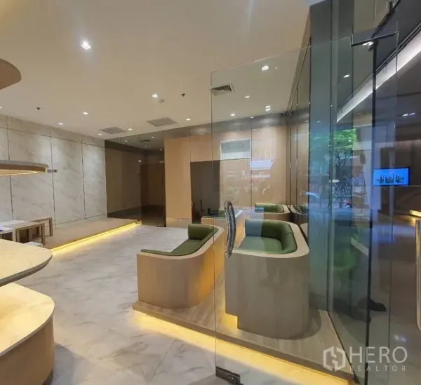 Retail Space for rent in Bang Rak, Bangkok - Built-in green booth seating with a glass entrance and warm accent lighting in a fitted retail space.