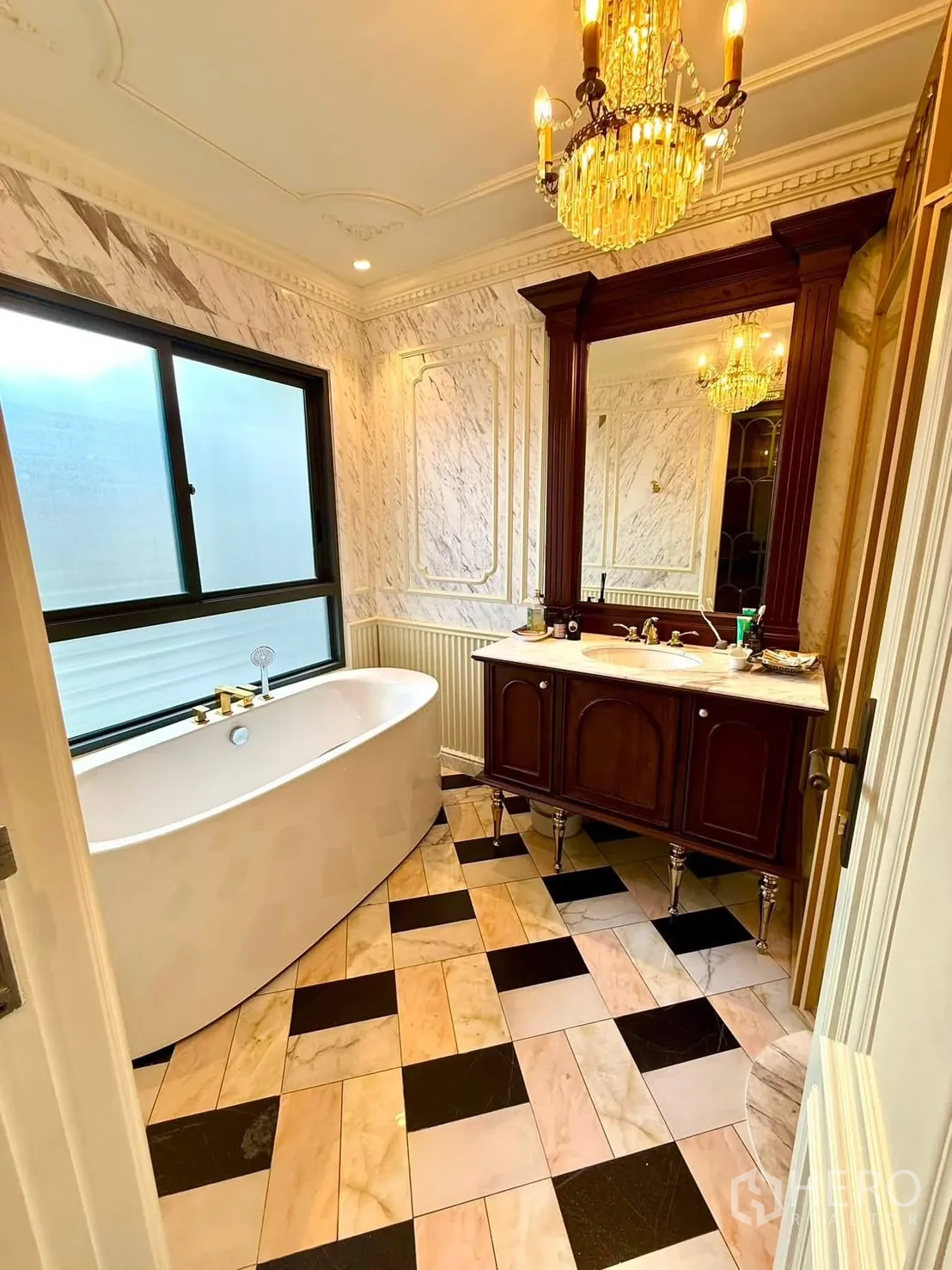 Detached House for rent in Bang Kapi, Bangkok - Luxurious bathroom with freestanding tub, marble walls, and chandelier.