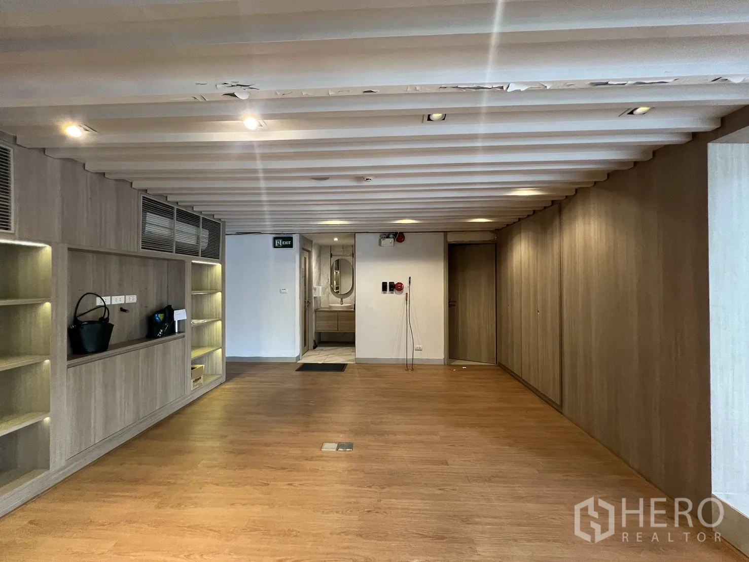 Retail Space for rent in Khlong Toei, Bangkok - Back-of-house area with built-in cabinets and restroom beyond.