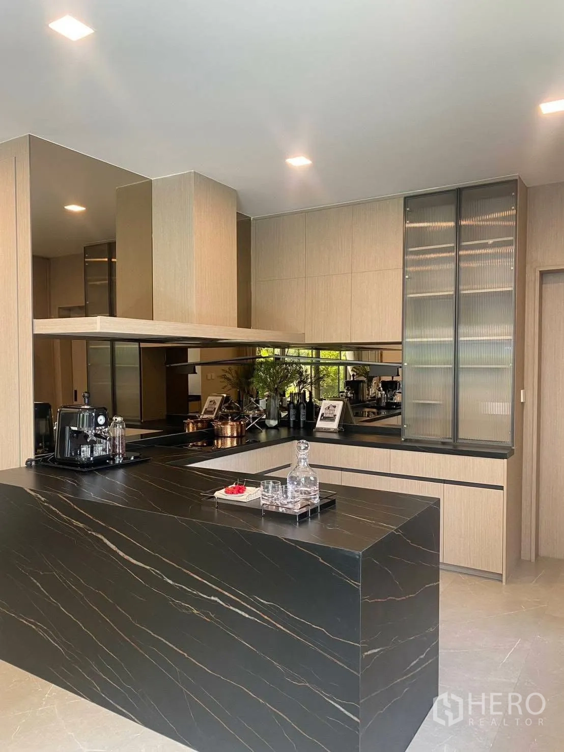 Detached House for rent or sale in Bang Phli, Samut Prakan - Modern kitchen with black stone island and light wood cabinetry.