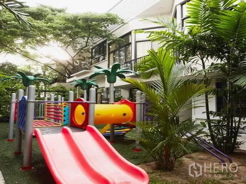 Detached House for rent in Khlong Toei, Bangkok - Shaded outdoor playground with slides beside the house and palm trees