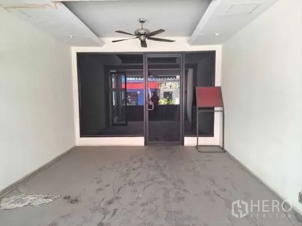 Retail Space for rent - Empty front room with glass doors and a ceiling fan, ideal for reception or display.