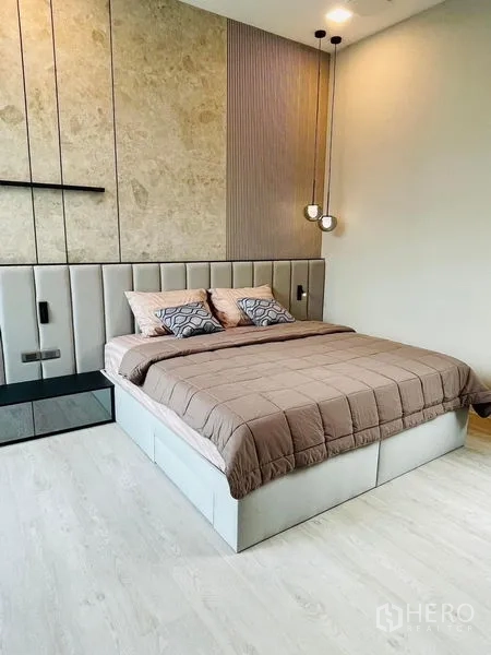 Detached House for rent - Contemporary bedroom with padded headboard, pendant lights and textured wall panels.