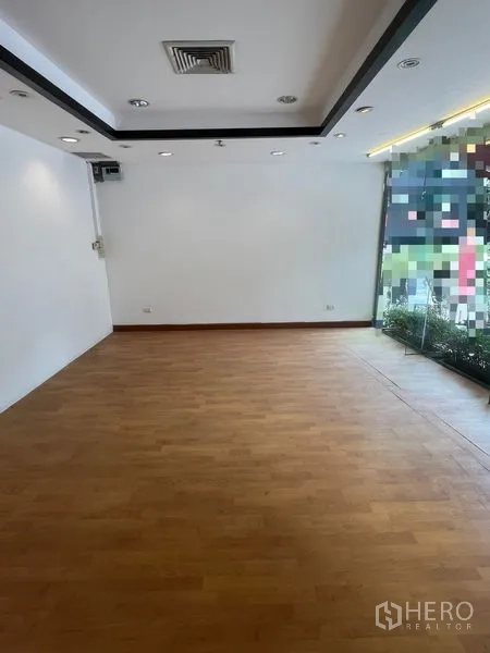 Retail Space for rent in Pathum Wan, Bangkok - Empty retail interior with wood flooring, white walls, recessed lights, and ceiling air vent.