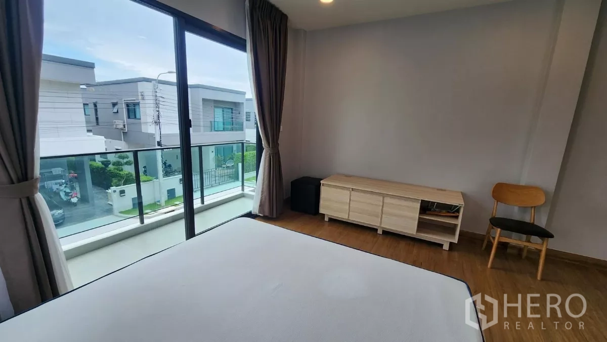 Detached House for rent in Bang Phli, Samut Prakan - View from master bedroom balcony over the community street with glass railing.