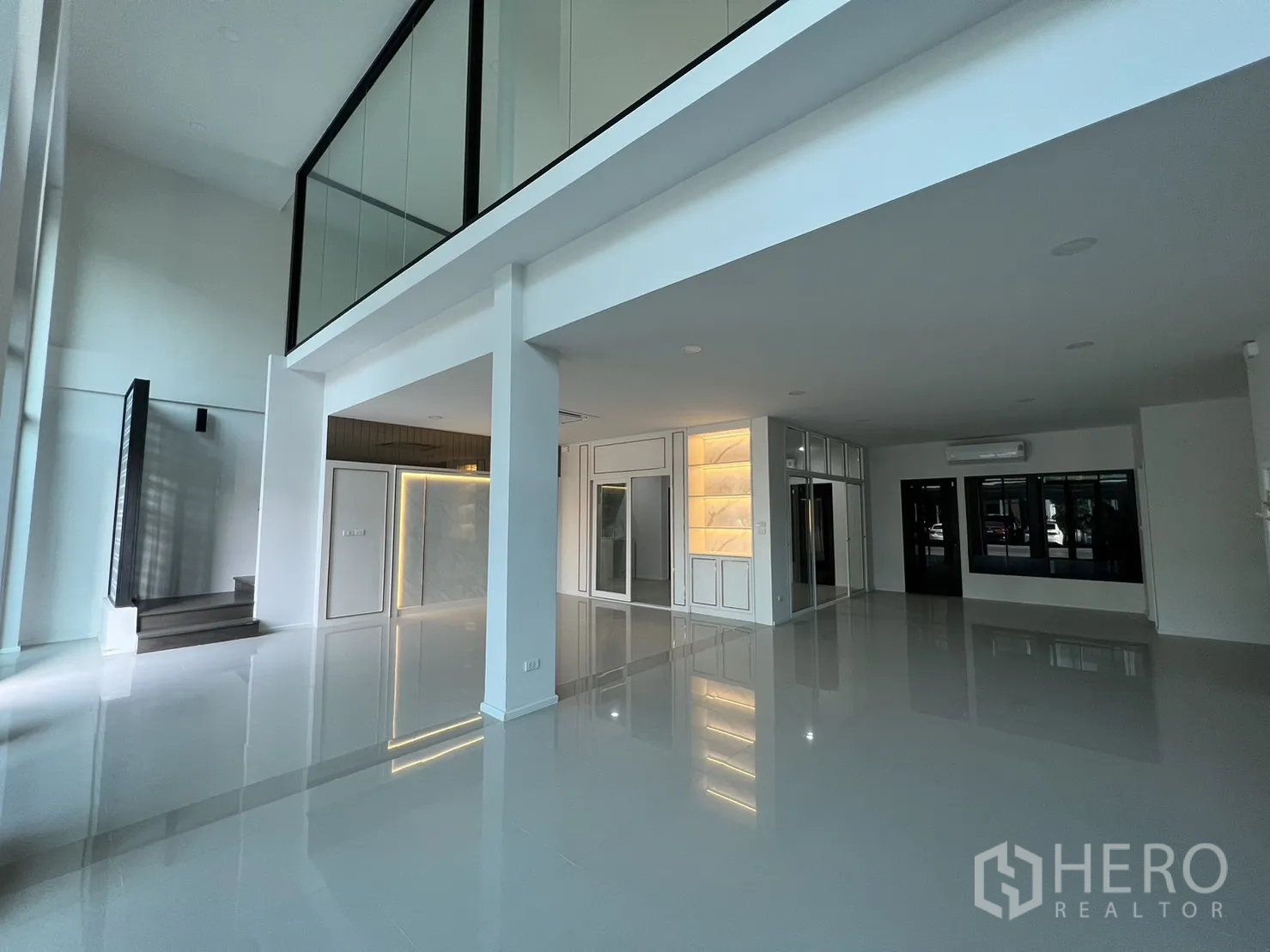 Home Office for rent in Bang Phli, Samut Prakan - Open area under the mezzanine with built‑in cabinets and accent lighting.