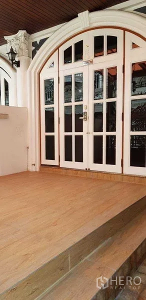 Home Office for rent in Watthana, Bangkok - Arched white front entrance with glass-paneled doors and a covered porch.