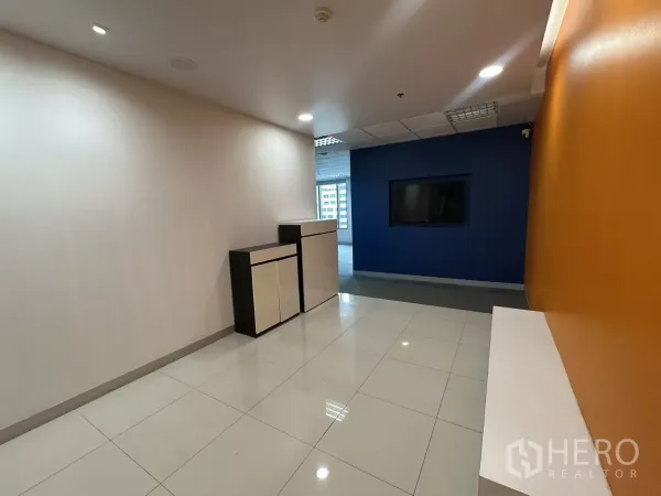 Office Space for rent in Watthana, Bangkok - Bright reception corridor with orange accent wall, blue feature wall and built-in cabinets.