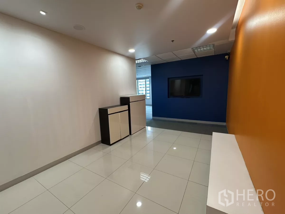 Office Space for rent in Watthana, Bangkok - Bright reception corridor with orange accent wall, blue feature wall and built-in cabinets.