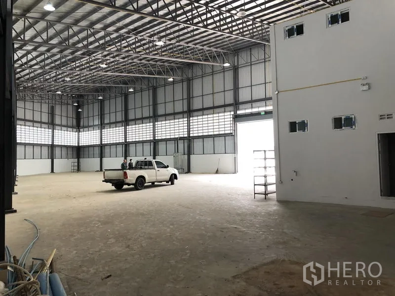 Factory for rent in Samut Prakan - Open production floor with bright ventilation panels and wide vehicle entrance.