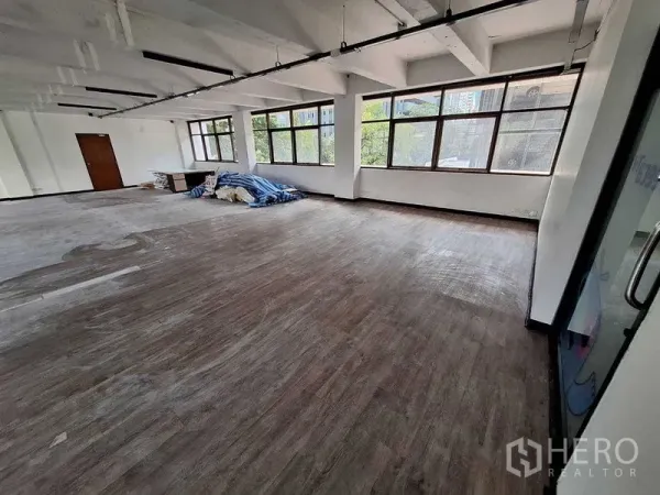 办公空间 出租在Watthana, Bangkok - 开放式工作区，角部大窗与玻璃入口门。
