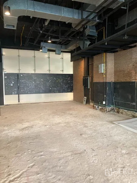 Retail Space for rent in Watthana, Bangkok - Industrial-style retail space showing exposed ducting, lighting tracks and utility panels.