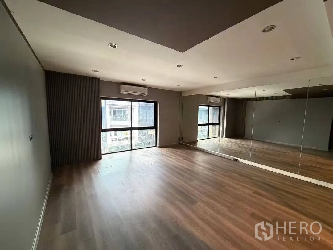 Home Office for rent in Watthana, Bangkok - Mirrored studio room from another angle with a big window and split-type air conditioners.