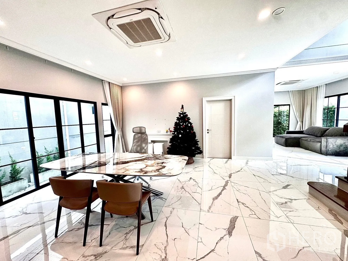 Detached House for rent in Bang Phli, Samut Prakan - Dining area with marble table, Christmas tree and sliding glass doors.