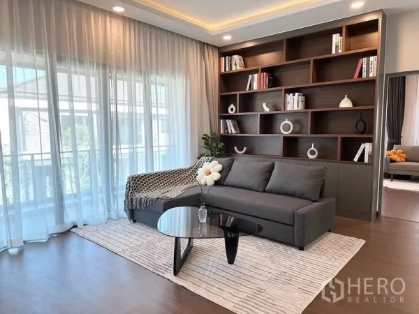 บ้าน ให้เช่าหรือขายในBang Phli, Samut Prakan - ห้องนั่งเล่นชั้นบนสว่าง พร้อมโซฟาและชั้นหนังสือบิลท์อินผนังไม้