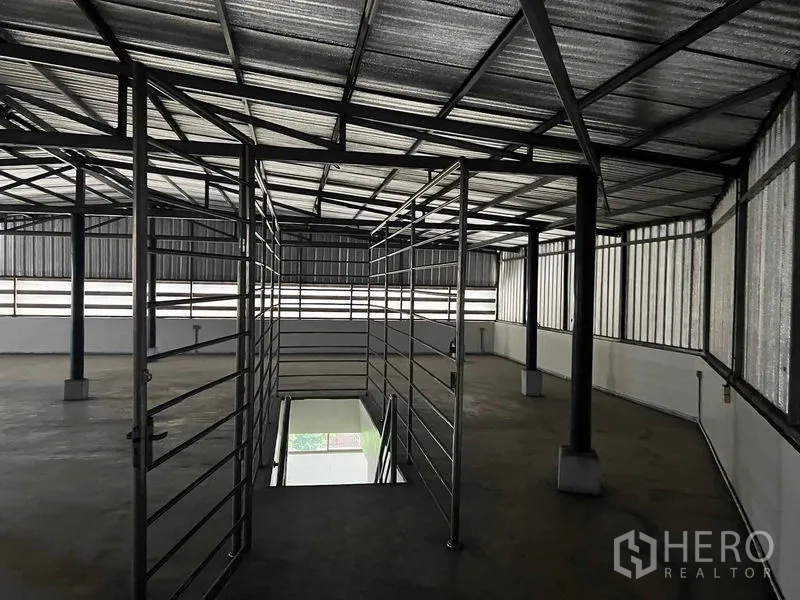 Home Office for rent in Taling Chan, Bangkok - Top-floor metal-roofed storage mezzanine with steel railings and open sides.