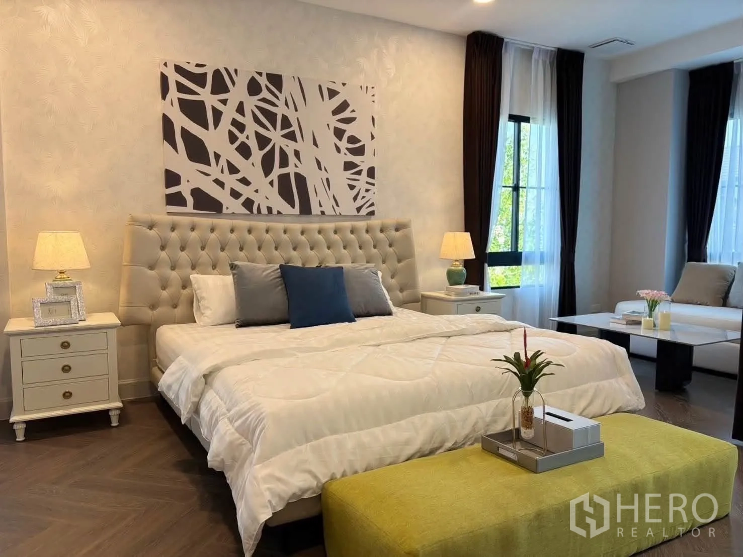 Detached House for rent in Saphan Sung, Bangkok - Master bedroom view showing tufted headboard and sitting area by windows.