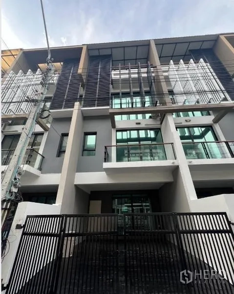 联排别墅 出租或出售在Khlong Toei, Bangkok - 现代联排别墅正面与带门车道的另一视角。
