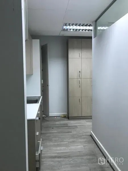 Retail Space for rent in Pathum Wan, Bangkok - Service corridor with lockers and light wood pantry cabinetry.