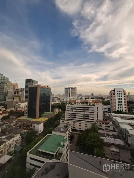 Condominium for rent in Bang Rak, Bangkok - High-floor city skyline view of Bang Rak and Silom from balcony.