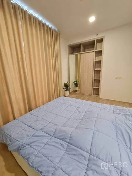 Condominium for rent - Bedroom storage with mirrored sliding-door wardrobe and open shelves.