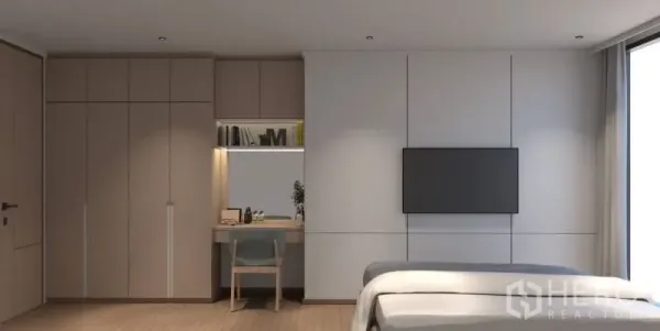 Condominium for rent or sale in Bang Rak, Bangkok - Spacious bedroom with wall-mounted TV, study desk, full-height wardrobes and a tall window.