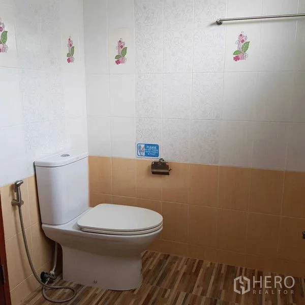 Home Office for rent in Watthana, Bangkok - Clean bathroom with toilet, bidet spray and tiled walls.