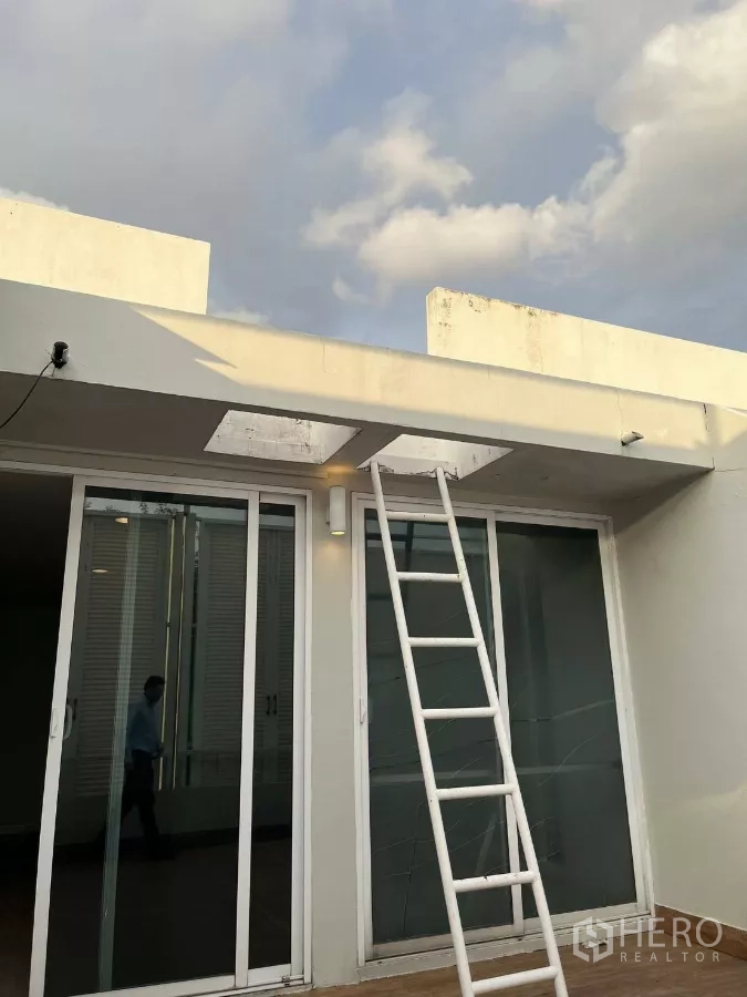 Home Office for rent in Khlong Toei, Bangkok - Rooftop access with sliding glass doors and fixed ladder.