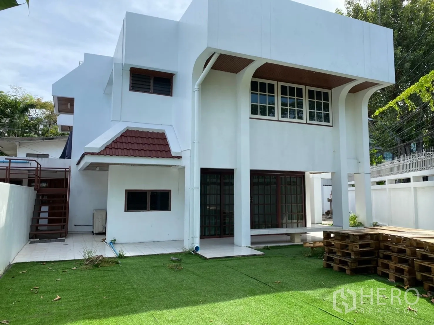 零售空间 出租在Khlong Toei, Bangkok - 两层白色独栋建筑，带草坪与推拉玻璃门