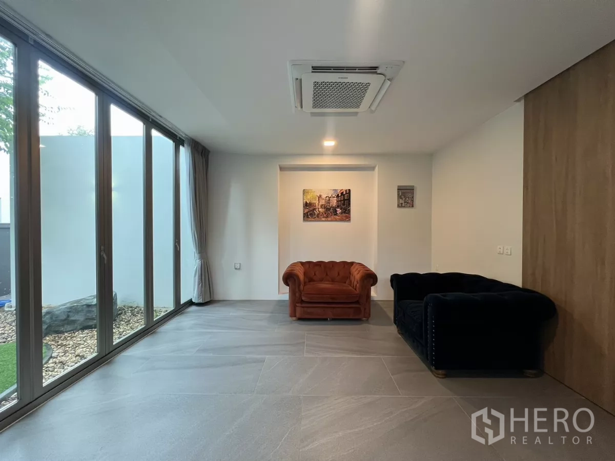 Detached House for rent in Saphan Sung, Bangkok - Family lounge with twin sofas and full-length sliding doors.