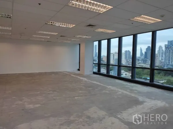 办公空间 出租在Bang Rak, Bangkok - 开放式办公室，网格吊顶与落地窗，远眺曼谷天际线。
