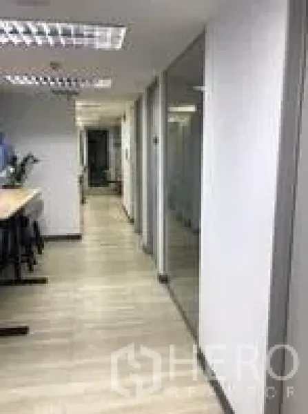 Office Space for rent in Khlong Toei, Bangkok - Bright corridor with wood floors and glass-partitioned meeting rooms.