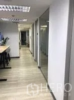 Office Space for rent in Khlong Toei, Bangkok - Bright corridor with wood floors and glass-partitioned meeting rooms.